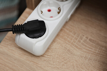 electrical extension cord with socket on table