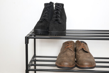 Metal shoe rack with shoes close up