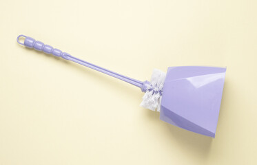 Toilet brush on yellow pastel background. Top view