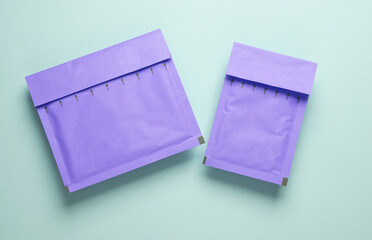 Purple Parcel envelopes on blue pastel background