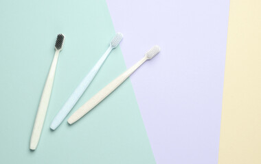 Two plastic toothbrushes on a pastel background. Oral hygiene