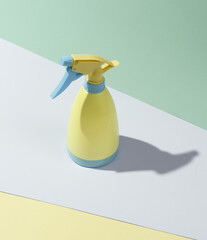 Blue-pink plastic spray bottle on pastel background. Minimalism