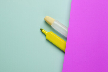 Accessories for creativity. Glue with a marker on a blue-purple background