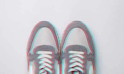 Gray running shoes on gray background. Casual sneakers. Top view