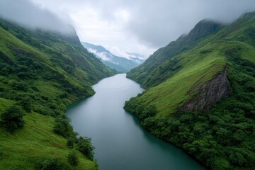 River Flowing Through Green Mountain Valley Under Cloudy Sky
