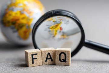 Magnifying glass over FAQ blocks symbolizing simplification, information access, and solving common queries