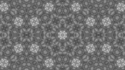 Abstract grayscale mandala illustration featuring intricate symmetrical geometric pattern composed of repeating floral and star shapes with a soft texture