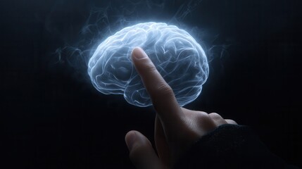 A hand touches a glowing, translucent brain in the dark.