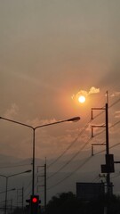 orange sunlight at dawn in the city street view with electric pole