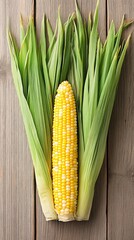 Corn displays its golden kernels nestled in fresh green husk, showcasing a bountiful harvest. Perfect for farm-to-table themes, cooking, and seasonal recipes