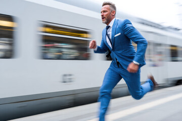 Businessman is running to catch the train