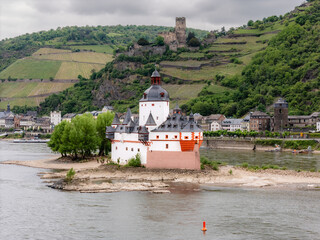 Pfalzgrafenstein toll castle on its Rhine island, with the town of Kaub and Gutenfels Castle on the hillside. A scenic view in Germany's UNESCO Upper Middle Rhine Valley, rich in history and vineyards