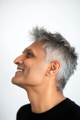 Fototapeta premium Modish men's spiky hair haircut - midlife indian man with short hair. A studio glamour portrait of a confident man. Pure white solid background. Visual idea of style for aging men.