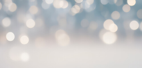 Blurred lights bokeh effect on a light blue and white background.