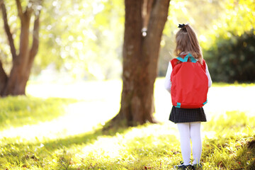 Children with briefcases for a walk in the park. School break. The beginning of the children's...