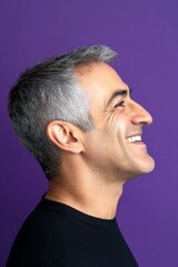 Obraz premium Trendy men's textured crop haircut - midlife middle eastern man with short hair. Visual idea of style for aging men. Purple solid background. A peaceful and radiant male in a confident pose.