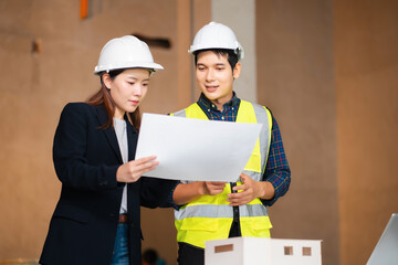Construction engineers discussion with architects at construction site or building site.