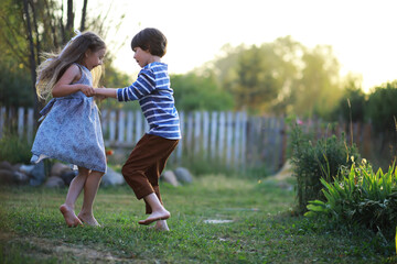 Fototapeta premium Children walk in the summer in nature. Child on a sunny spring morning in the park. Traveling with children.