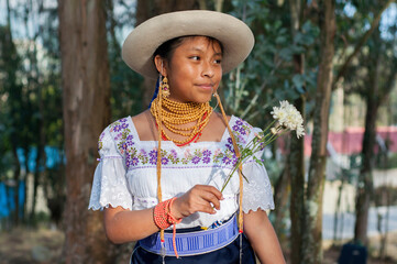 Indigenous girl wearing traditional clothes holding flowers in guatemala