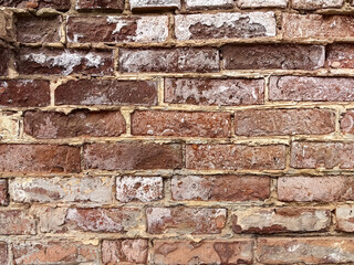 textured old  red brick wall with worn surface