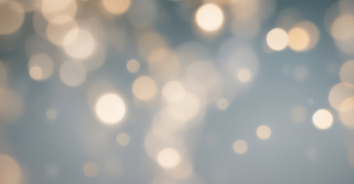 Abstract blurred background with golden bokeh lights on a soft blue surface.