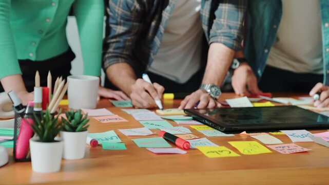 Skilled business team looking at laptop and pointing logo design while making decision to choosing main theme color and planning marketing campaign. Smart start up group working together. Symposium.