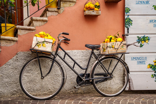 Vintage bicycle with baskets filled with lemons in the old town of Limone sul Garda, Lake Garda, Italy.