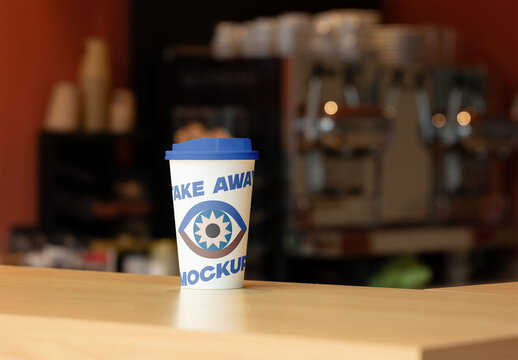 Takeaway coffee cup mockup placed on a wooden counter