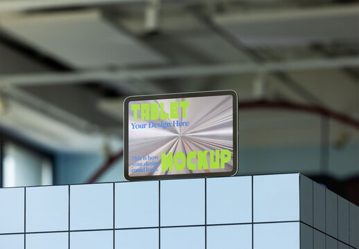 A tablet mockup showcased on a blue tiled surface.