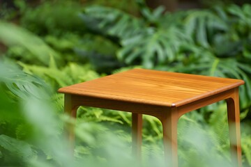 Wooden side table on display in a green garden with natural lighting for relaxation