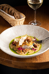 Fried fish on creamy mushroom sauce, paired with crisp white wine and warm bread
