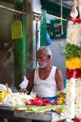 a garland maker in indian streets