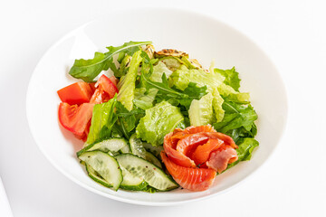 Fresh lettuce, ripe tomatoes, and flavorful salmon create a colorful and healthy meal