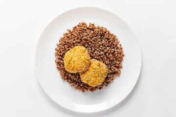 Two golden patties on a bed of buckwheat make a nourishing meal option