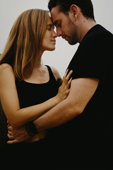 Intimate embrace of caucasian couple: young adults sharing a tender moment