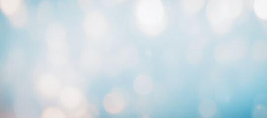 Fototapeta premium Abstract background with blurred light spots in blue and white tones.