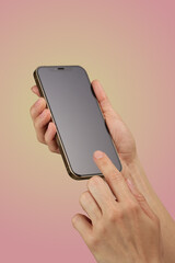 female hand holding and clicking , typing on smartphone display isolated on pink background, mockup , woman using smart phone