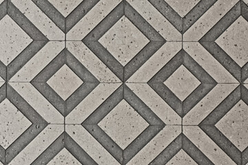 Obraz premium A geometric pattern of interlocking diamond shapes in a concrete texture
