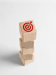 Fototapeta na wymiar Stack of wooden cubes showing target achieving business objective