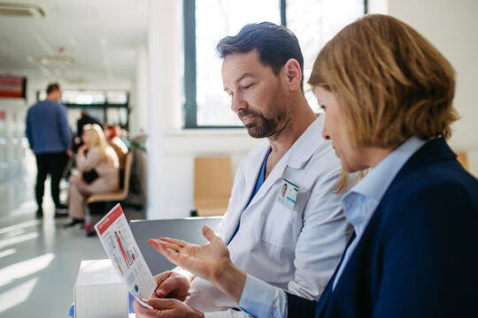 Pharmaceutical rep and doctor discussing drug samples and prescriptions