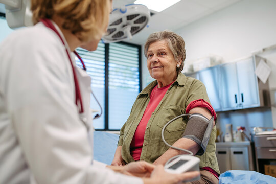 Senior woman having blood pressure checked, preventive care.