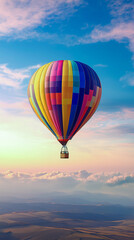 Rainbow hot air balloon in the sky at dawn. Vertical photo. Freedom concept. Colors of LGBT community