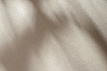 Tan paper texture or background with lights and shadows.