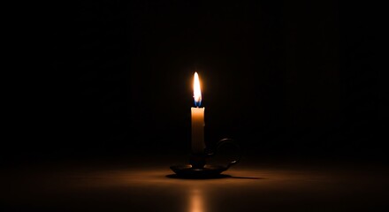 Candle Burning in Dark Room Casting Light