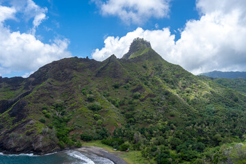 Coastal cliffs and turquoise bay near Puamau, Hiva Oa, Marquesas Islands, French Polynesia