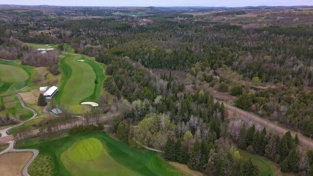 Drone wide shot of forest landscape in Canada near TPC Toronto Osprey Valley. Forward wide shot. Canadian suburb district with woodland. Empty lawn field.