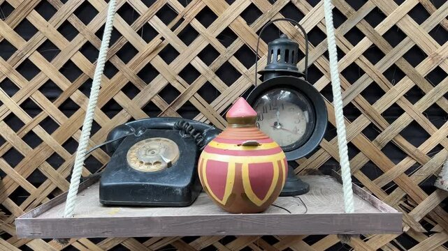 An old telephone, clock and terracota lakshmi bhandar used by Zamindar in Bengal.