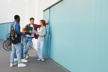 Group of young adults discussing outdoors