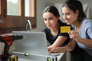 Couple reforming house buying online in the kitchen