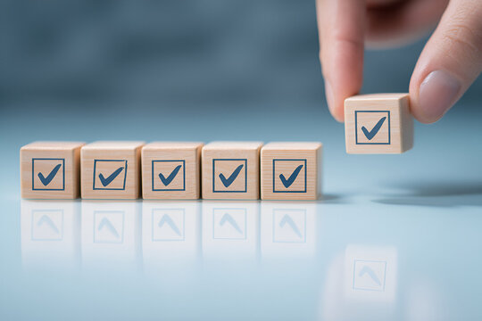 Completion confirmation symbolized by wooden blocks displaying checkmarks arranged aligning objectives
